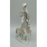 A LLADRO FIGURE OF A FEMALE wearing a scarf, walking her borzoi dog on a windy day 39cms high