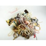 COSTUME DRESS JEWELLERY, a plastic container full and including beads, earrings, necklaces, bangles,