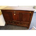 A C19TH LANCASHIRE CHEST having a three panel frontage, two drawers and hinging lid on style feet,