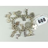 SILVER FLAT CURB LINK CHARM BRACELET with assorted charms to include lion, wild boar, Golden Gate