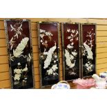 FOUR C20TH ORIENTAL PANELS in lacquer with applied peacocks and foliage and having decorative