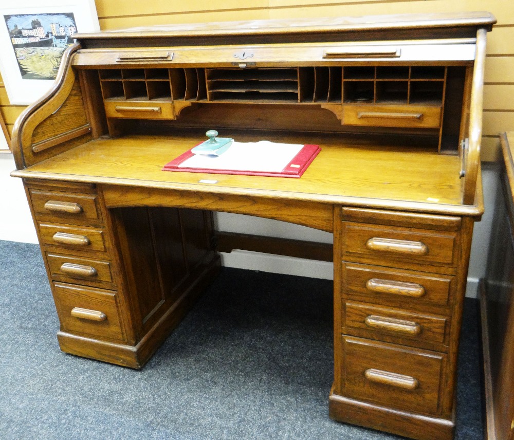 AN EXCELLENT VINTAGE OAK ROLL-TOP DESK having nine exterior drawers and a good interior