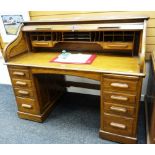 AN EXCELLENT VINTAGE OAK ROLL-TOP DESK having nine exterior drawers and a good interior