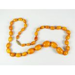 GRADUATED STRING OF AMBER BEADS, 75cms long approx. 73 grams approx.