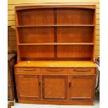 A G-PLAN OR G-PLAN STYLE TEAK DRESSER with three cupboard base, three drawers and an open rack