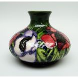 A MOORCROFT POTTERY SQUAT BOTTLE- SHAPED VASE in the 'Anemone Tribute' pattern, limited edition 5/32