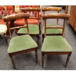 A SET OF FOUR ANTIQUE DINING CHAIRS with green velvet seats, with bentwood backs and on turned front