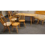 A MID TO LATE C20TH ERCOL BLONDE DINING TABLE AND CHAIR SET comprising rounded rectangular dining