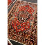 A GOOD PERSIAN WOOL CARPET with multicoloured floral medallion design, 206 x 143cms