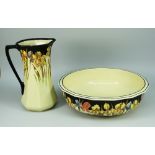 A GOOD ROYAL DOULTON POTTERY TOILET JUG AND BASIN decorated with flowers; basin 42cms high, jug