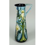 A MOORCROFT POTTERY SLENDER JUG in the 'Calla Lily' pattern circa 2002, 24cms high (boxed)