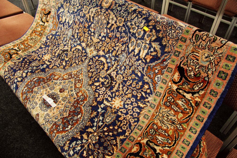 A GOOD PERSIAN CARPET from the Poshtkohi region in rich brown and blue geometric design 244 x