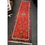 A PERSIAN CARPET RUNNER with large floral centred design, 300cms long