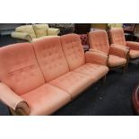 A GOOD ERCOL BLONDE THREE-PIECE SUITE with detachable buttoned orange upholstered cushions