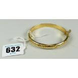 9 CARAT GOLD SCROLL AND FOLIATE ENGRAVED BANGLE IN ASSOCIATED BOX 7.6 grams approx.