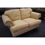 MODERN TWO SEAT SOFA having scroll arms in ribbed mustard coloured upholstery