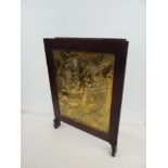 LATE 20TH CENTURY BRASS ARTS & CRAFTS PANEL with repousse decoration of circular scene with
