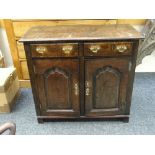 SMALL NINETEENTH CENTURY DRESSER BASE having panelled cupboard doors below two drawers on stile-