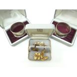PAIR OF INDIVIDUALLY CASED SILVER NAPKIN RINGS together with a pair of 9ct yellow gold machine-