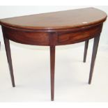 GEORGE III MAHOGANY HALF ROUND FOLD-OVER TOP TEA TABLE having a single drawer on tapered supports,