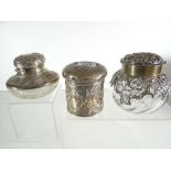 THREE SILVER / PART-SILVER DRESSING TABLE JARS one with cut-glass base and hinged lid, the second of
