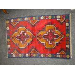 BALUCHI RUG, blue and red ground with a geometric design, 138 x 89cms