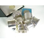 SIX ENGLISH HALLMARKED SILVER NAPKIN RINGS various designs together with an Indian silver similar,