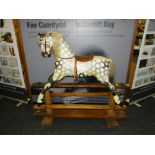 VINTAGE ENGLISH ROCKING HORSE with painted mottled body, with main, saddle and stirrups to a pine