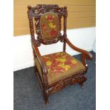 NINETEENTH CENTURY LOW COUNTRIES CARVED ARMCHAIR having floral tapestry feet and back