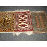 THREE VARIOUS PATTERNED WOOLEN PERSIAN PRAYER RUGS, 69 x 94cms, 94 x 67cms and 82 x 92cms