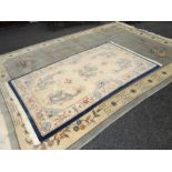 TWO PALE BLUE WOOLEN WASHED CHINESE RUGS with flower and dragon designs, 220 x 122cms and 250 x