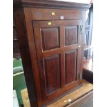 ANTIQUE OAK PANELLED HANGING CORNER CUPBOARD with three-shelf interior