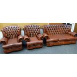 BROWN LEATHER THREE-PIECE SUITE comprising three seater sofa with studded back and two matching