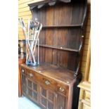 VINTAGE DRESSER having paneled two cupboard base, three drawers and open rack, 122cms wide