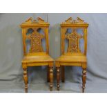 TWO MAHOGANY HALL CHAIRS with carved and shaped backs
