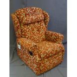 A DARK AND FLORAL UPHOLSTERED MANUAL RECLINING CHAIR