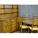 AN ERCOL MEDIUM COLOUR DINING SUITE consisting of dresser with four central drawers flanked by two