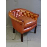 A LEATHER OXBLOOD BUTTON BACK TUB CHAIR