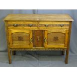 AN OAK TWO DRAWER OVER TWO BASE CUPBOARDS SIDEBOARD with carved detail and ringed pull handles