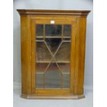 A SINGLE DOOR GLASS PANED MAHOGANY HANGING CORNER CUPBOARD, 89cms height, 72cms width