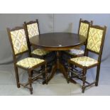 A CIRCULAR EXTENDING DINING TABLE and four floral upholstered dining chairs