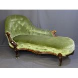 A VICTORIAN WALNUT CHAISE LONGUE (some fading) with shaped back in button draylon upholstery,