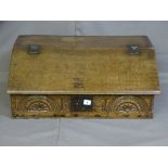 AN OAK BIBLE BOX, late 18th/early 19th century with iron hinges to the slope and a carved lunette