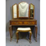 A MID CENTURY MAHOGANY CONCAVE FRONT DRESSING TABLE with triple mirror on tapered legs with pad feet