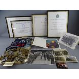 A COLLECTION OF MILITARY CAP BADGES, buttons and embroidered tunic emblems with a quantity of framed