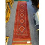 A MESHWANI RUNNER red ground with repeating central diamond pattern and continuous border, 260 x