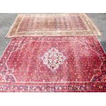 AN IRANIAN RED GROUND CARPET AND ONE OTHER, classical colourful design with a triple bordered