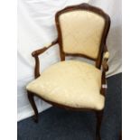 A FRENCH REGENCY STYLE MAHOGANY ELBOW CHAIR with cream floral seat and back and padded arms