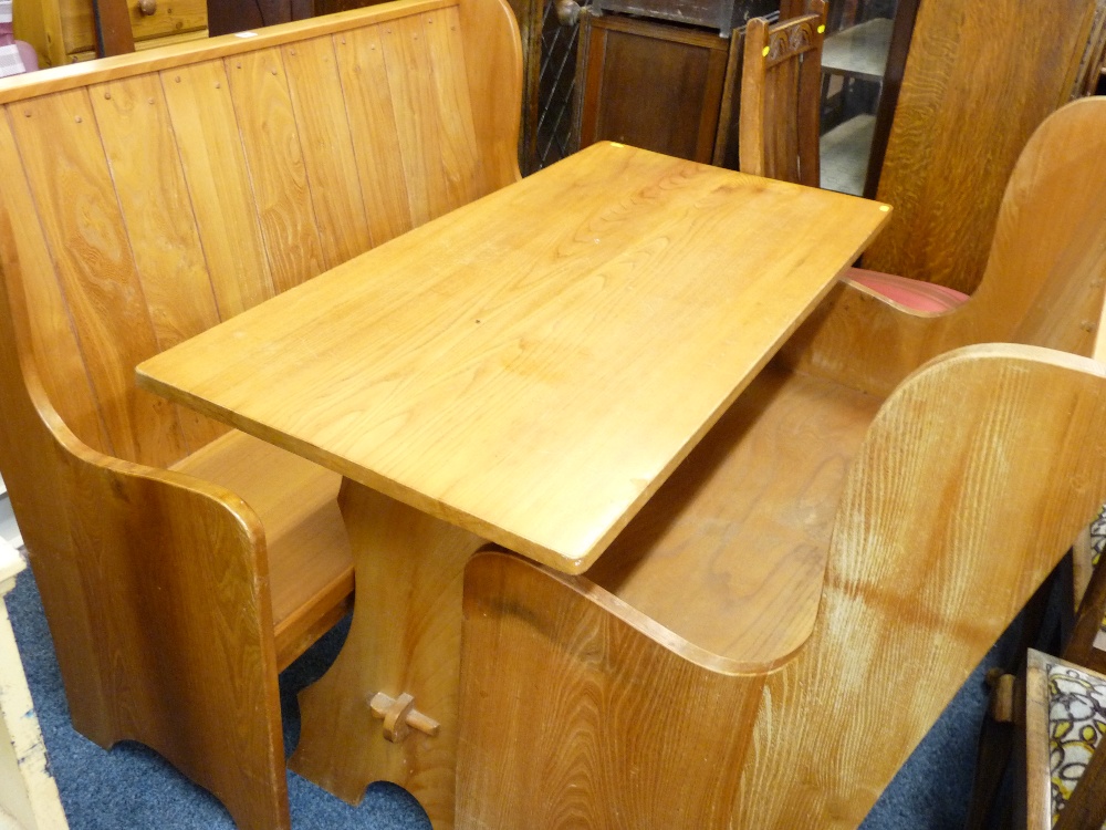 A LIGHTWOOD BREAKFAST SUITE of oblong pedestal table and a pair of wing backed settles