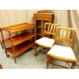 A THREE TIER BARLEY TWIST TEA TROLLEY, an oak single door bookcase, two vintage side chairs and a